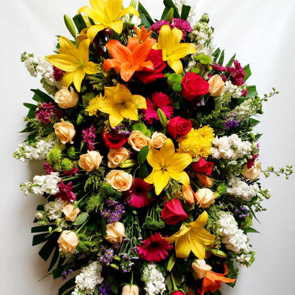 Large standing spray of mixed colorful flowers on an easel