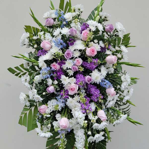 Standing floral spray with pink roses, white daisies, and purple blooms