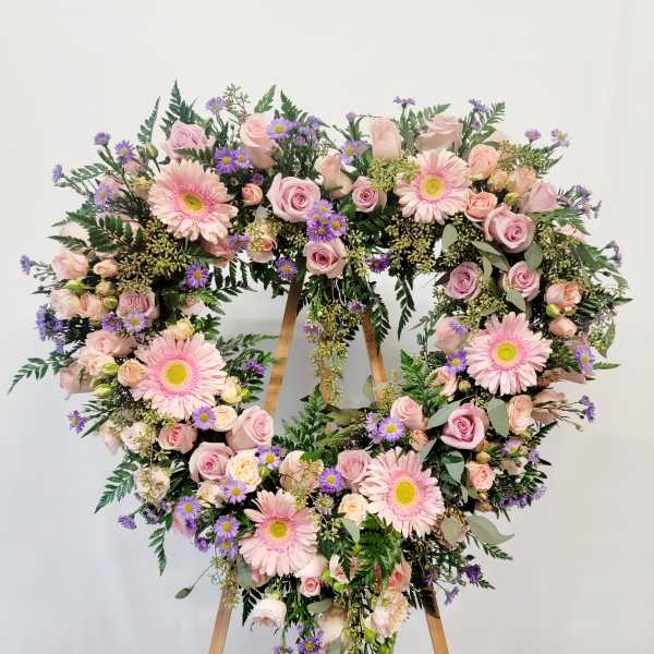 Heart-shaped floral wreath with pink roses and gerbera daisies