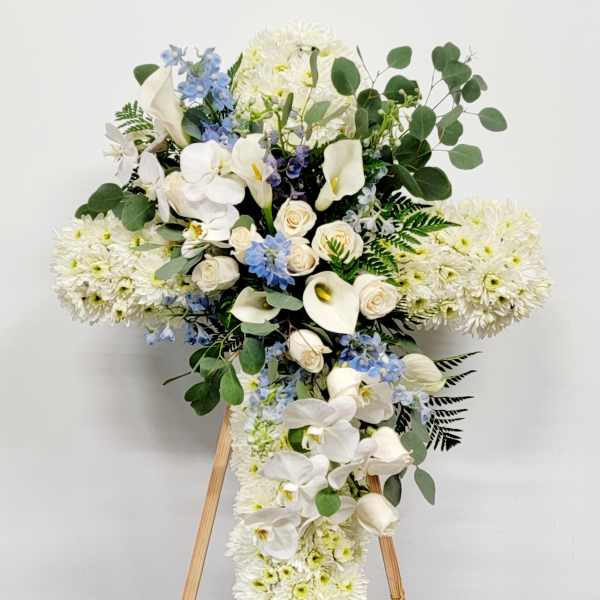 White floral standing spray with orchids, roses, and chrysanthemums