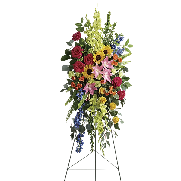 Standing floral spray with roses, lilies, sunflowers, and blue delphinium