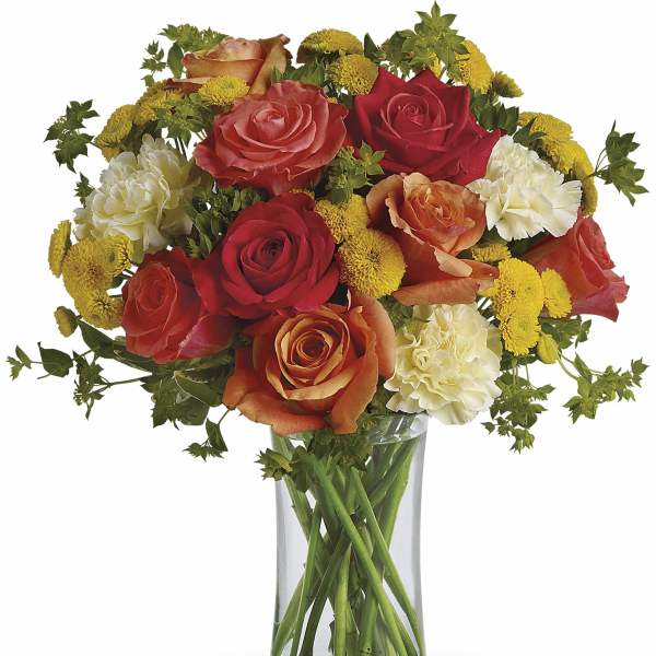 Mixed roses and carnations in a clear glass vase