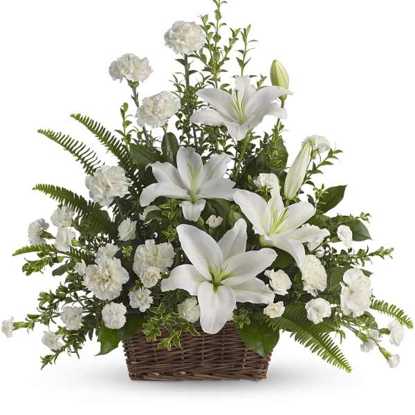White lilies and carnations arranged in a wicker basket