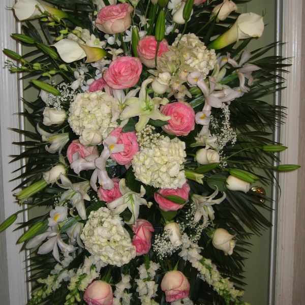 Tall standing floral spray with pink roses, white calla lilies, and white hydrangeas