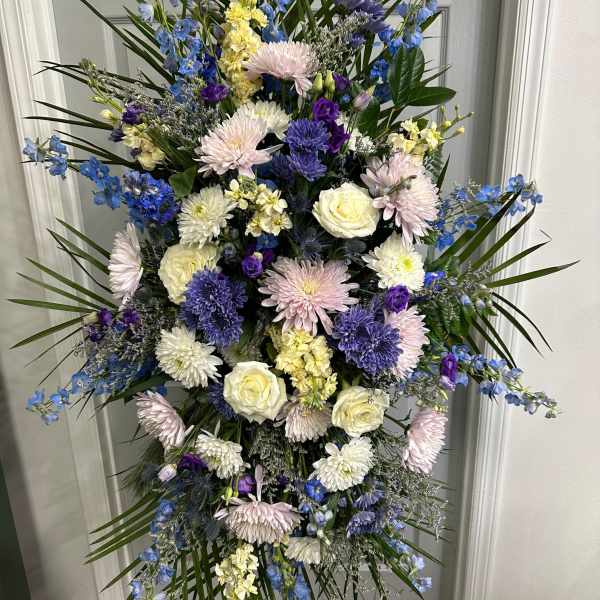 Tall standing floral spray with blue, white, and pink flowers