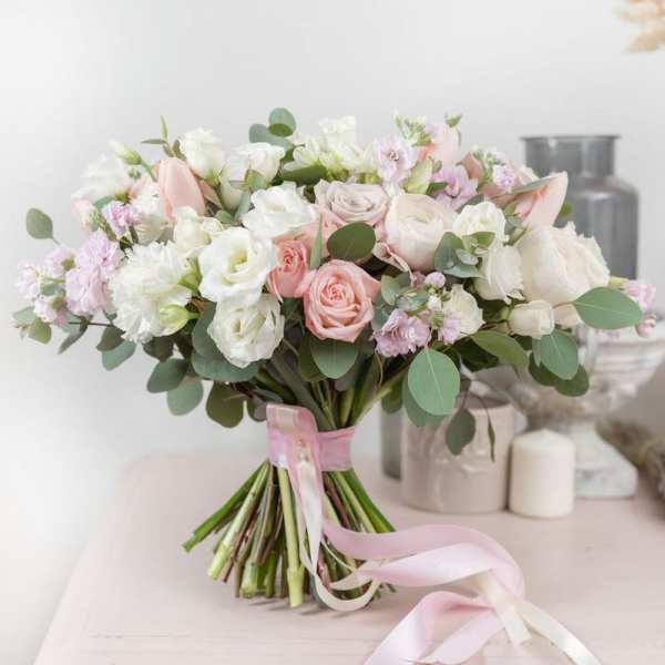 Bouquet of blush and white roses with pink ribbon