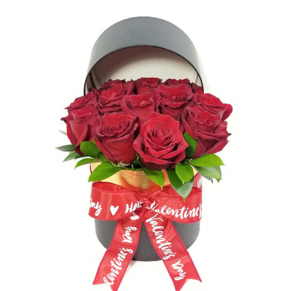 Red roses in a black hatbox with a red Valentine ribbon