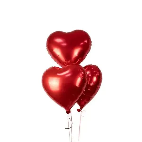 Three red heart-shaped balloons on strings