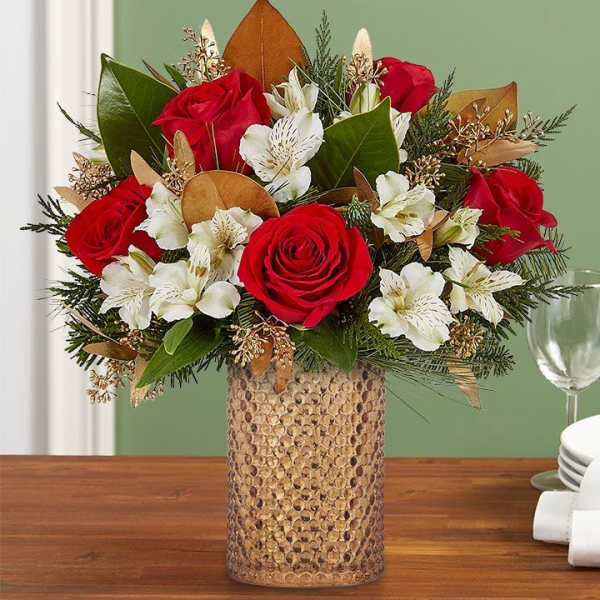 Red roses and white lilies in a textured gold vase