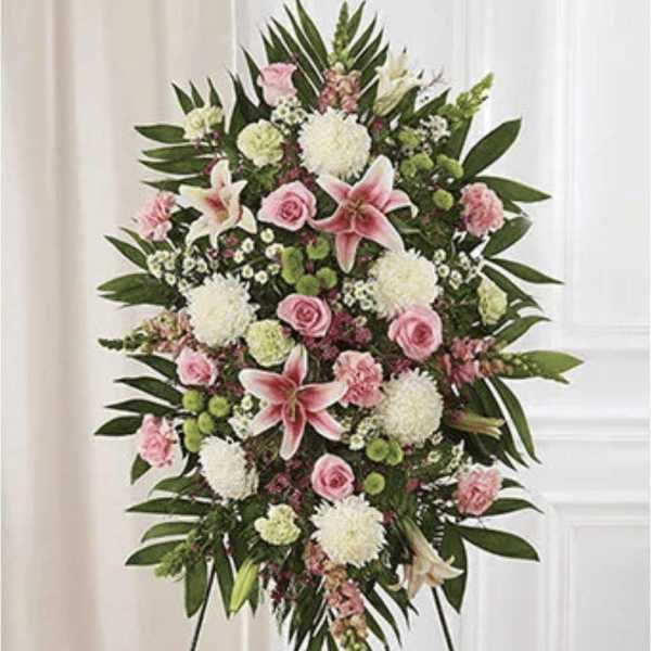 Standing floral spray with pink lilies, roses, and white blooms