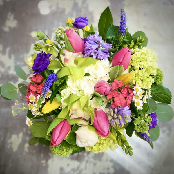 Colorful mixed bouquet with pink tulips, purple blooms, and white flowers