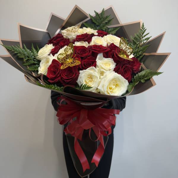 Large bouquet of red and white roses with a red ribbon