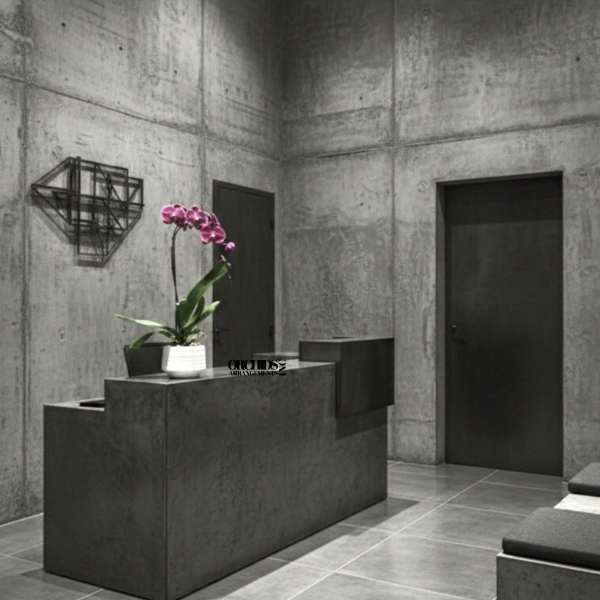 Pink orchid in a white pot on a dark pedestal in a gray room