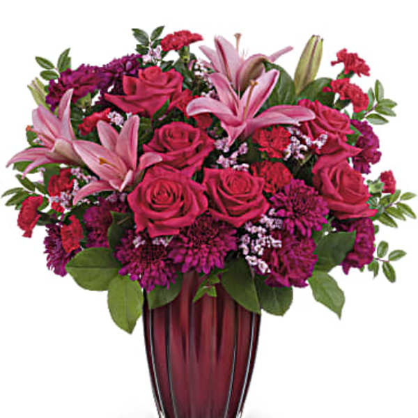 Pink lilies and roses in a burgundy vase