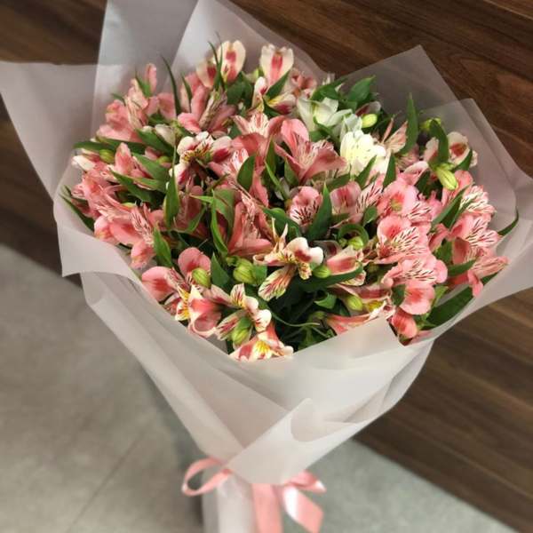 Bouquet of pink and white alstroemeria wrapped in white paper