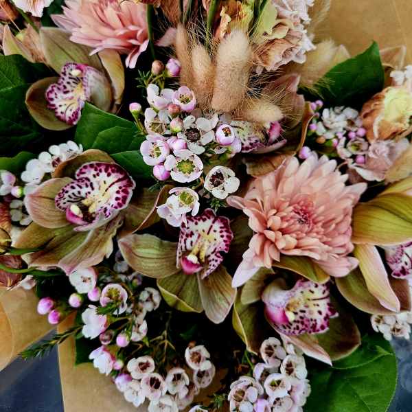 Bouquet of pink and cream flowers with spotted orchids and small white blossoms