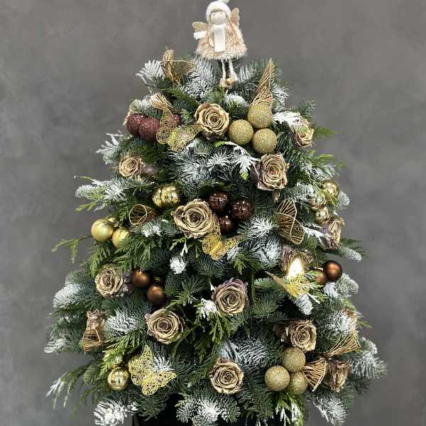 Christmas tree arrangement with gold roses and ornaments in a black box