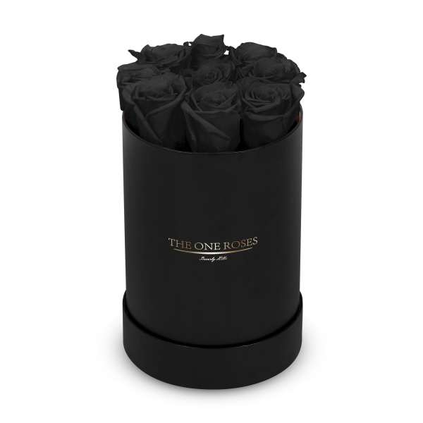 Black roses arranged in a round black box