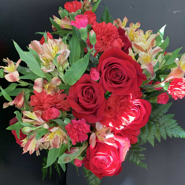 Bouquet of red roses, carnations, and striped alstroemeria