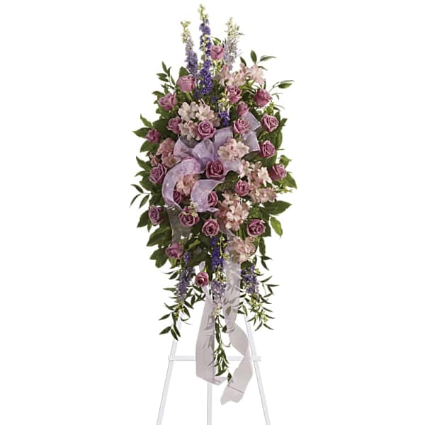 Tall lavender and pink floral spray on a white easel