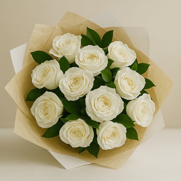 Bouquet of white roses wrapped in tan paper