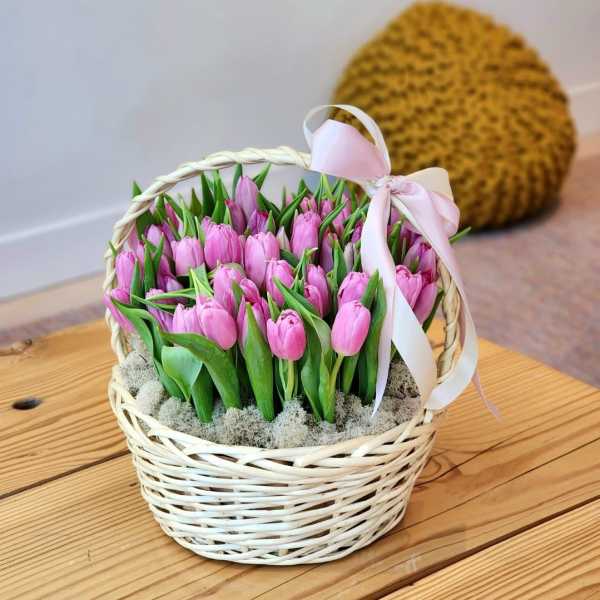 Basket of pink tulips with a pale ribbon bow