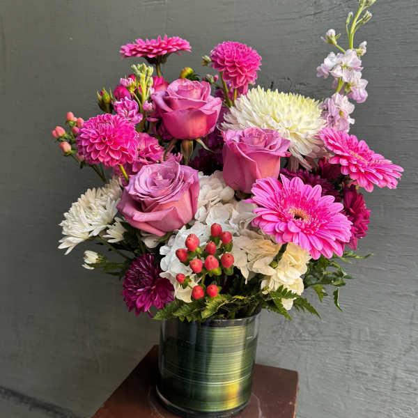 Pink and white mixed bouquet in a green tin vase