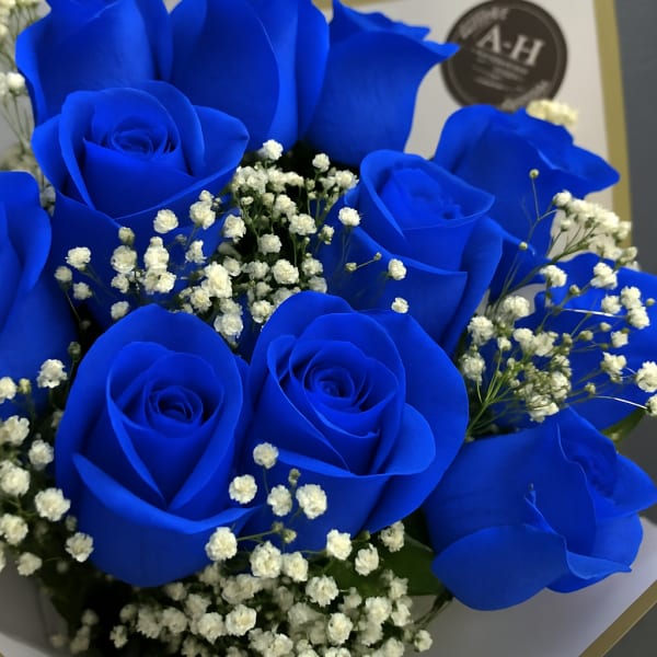 Bouquet of vivid blue roses with white baby's breath
