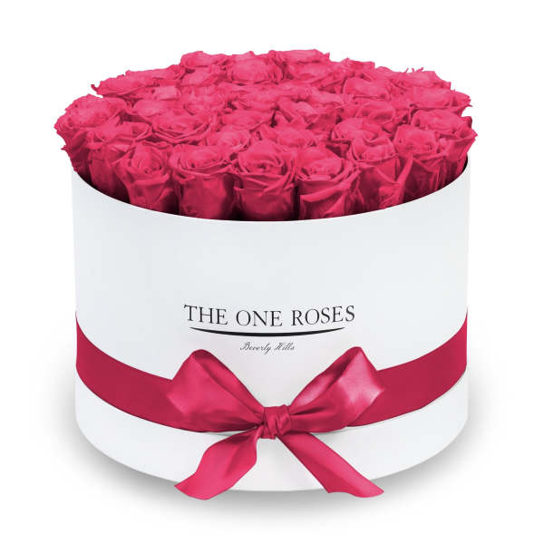 Round box of hot pink roses with a satin ribbon