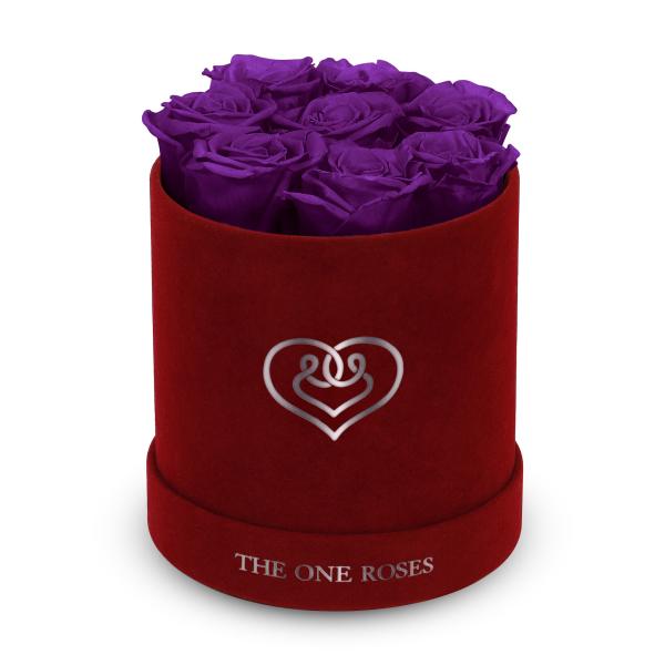 Purple roses in a red velvet hat box with a heart logo