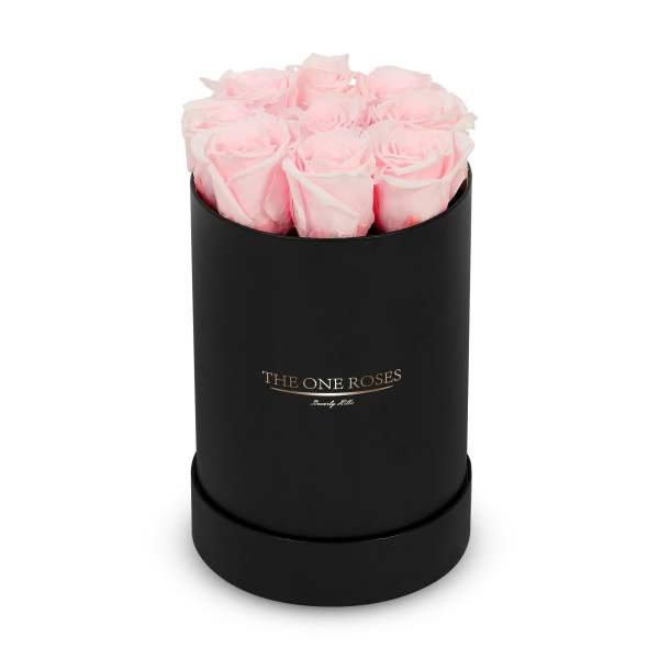 Pink roses arranged in a black cylindrical box