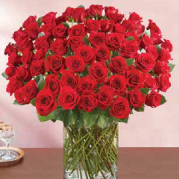 Large bouquet of red roses in a clear glass vase