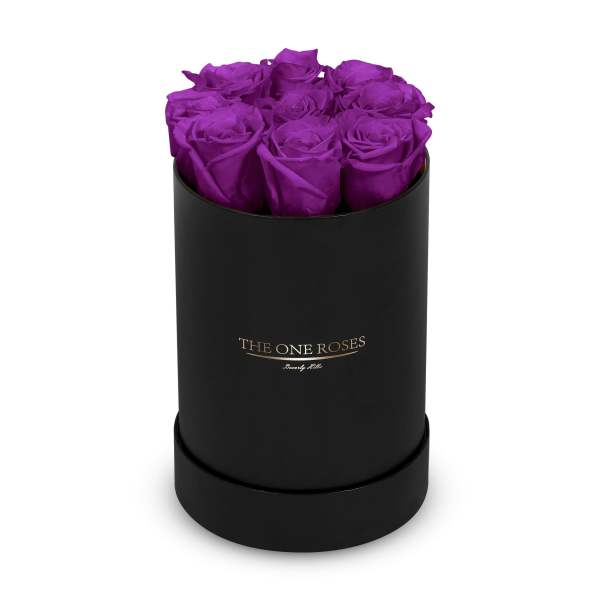 Purple roses arranged in a black cylindrical box