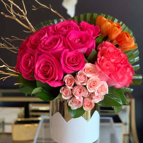 Bouquet of pink, peach, and orange roses in a white box