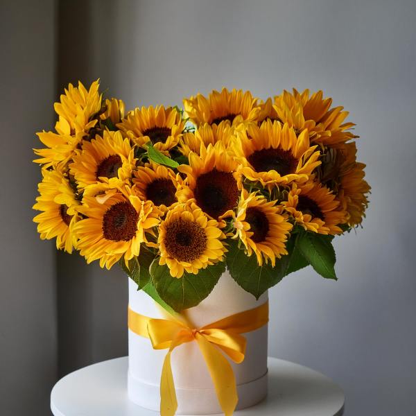 Sunflower bouquet in a white hat box with a yellow ribbon