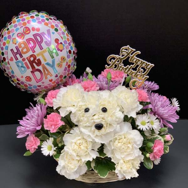 Birthday flower basket with a polka-dot balloon and pink and white blooms