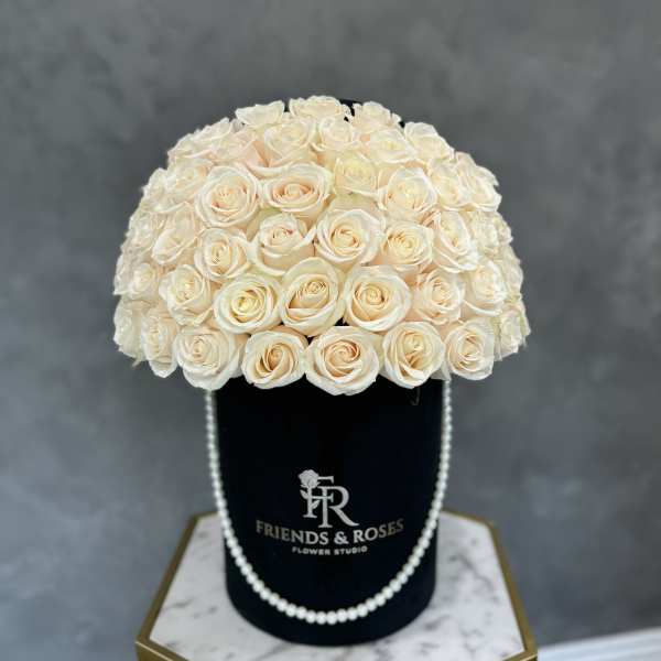 Cream rose bouquet in a black hat box with pearl trim