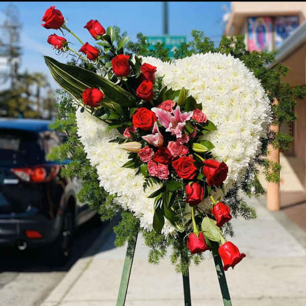 Heart-shaped standing floral spray with red roses and white flowers