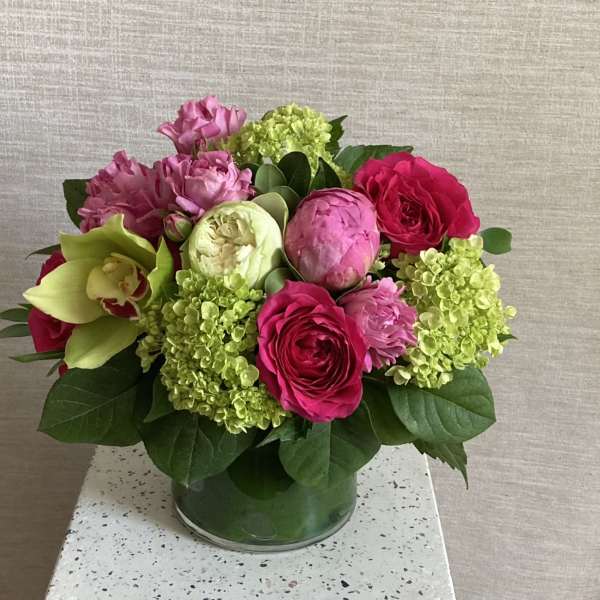 Pink and green floral arrangement in a glass vase