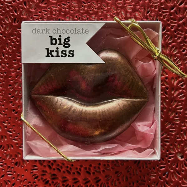 Boxed dark chocolate shaped like lips with pink tissue paper