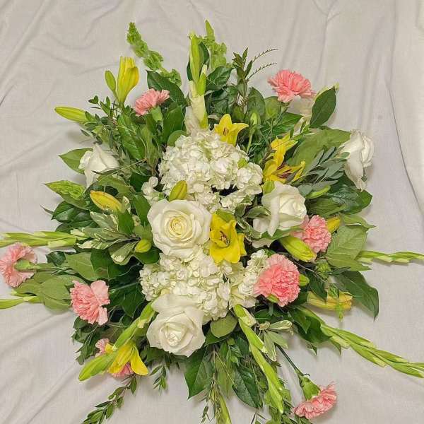 Round bouquet of white roses, lilies, and pink carnations