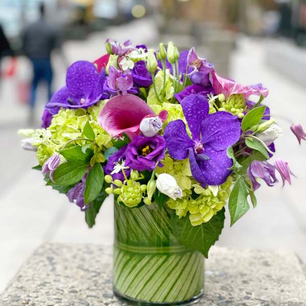 Purple and pink mixed bouquet in a glass vase