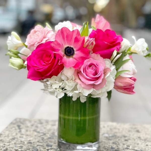 Pink and white bouquet in a clear glass vase