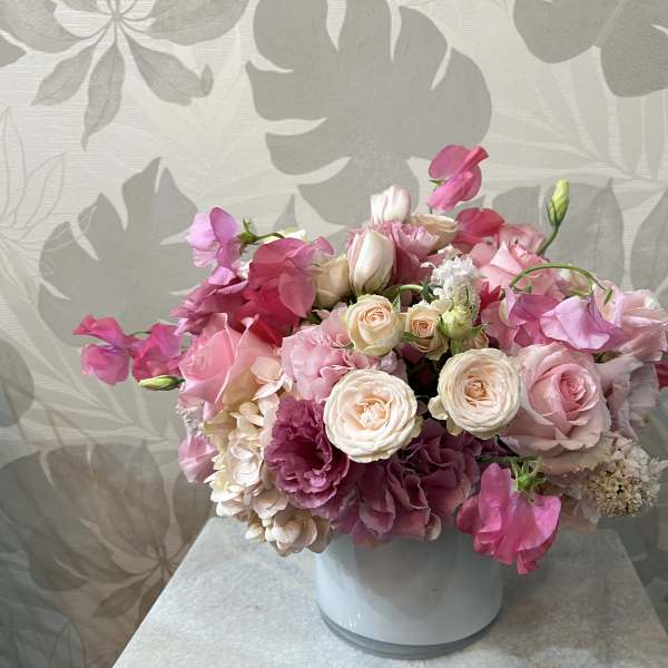 Pink and white bouquet in a white vase