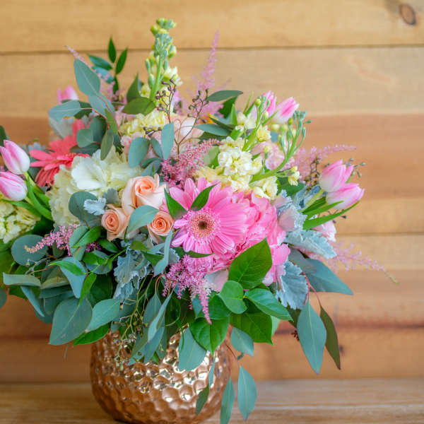 Pink and white mixed bouquet in a hammered gold vase