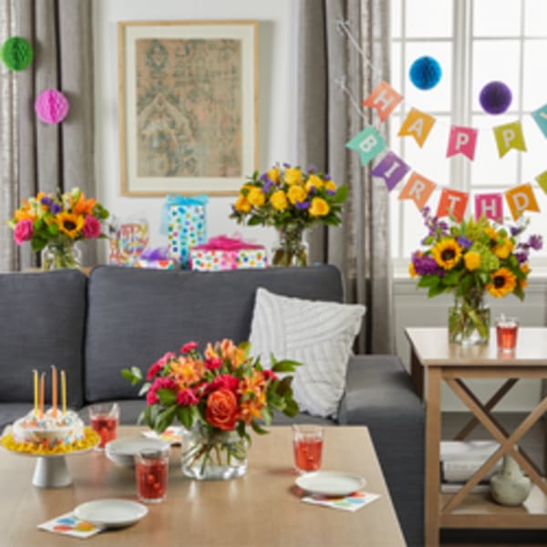 Birthday party room with colorful flower arrangements and decorations
