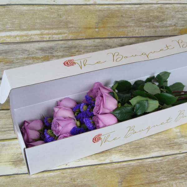 Lavender roses in a white bouquet box