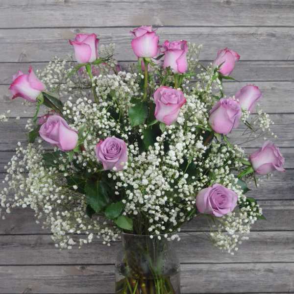 Pink roses and baby's breath in a clear glass vase