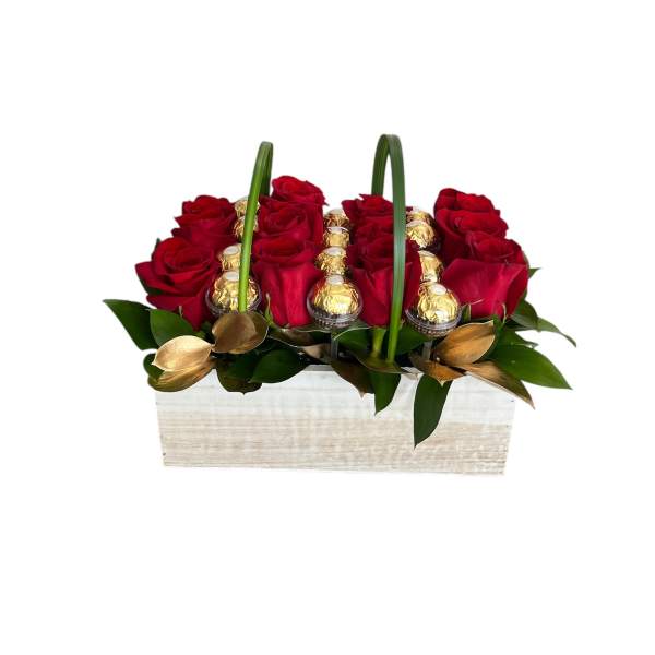 Red roses and gold-wrapped chocolates in a white wooden basket