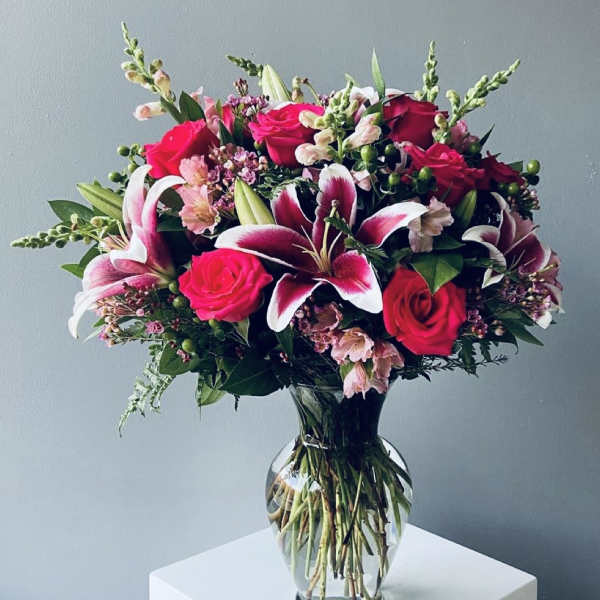 Bouquet of pink roses and lilies in a clear glass vase